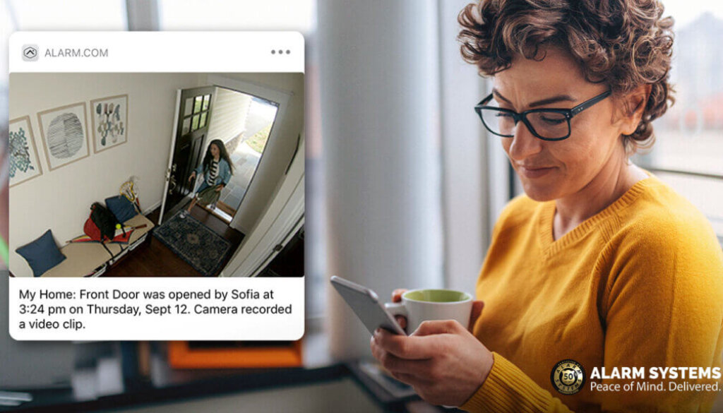 woman checking her phone for a mobile notification from her home security camera that her children have come home.